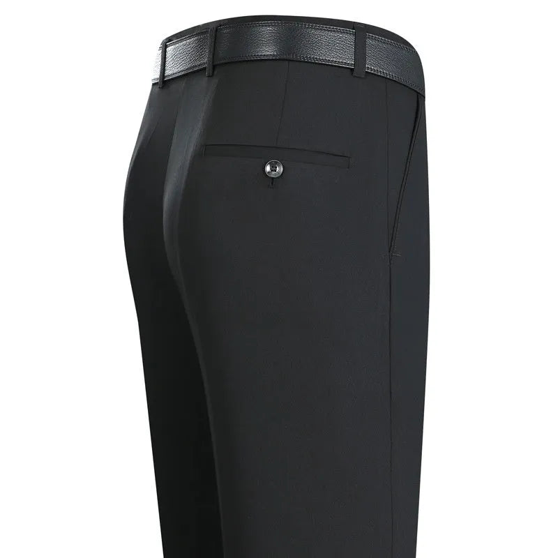 Man wearing dark blue straight-leg suit trousers with a high waist, made from a mulberry silk blend fabric.