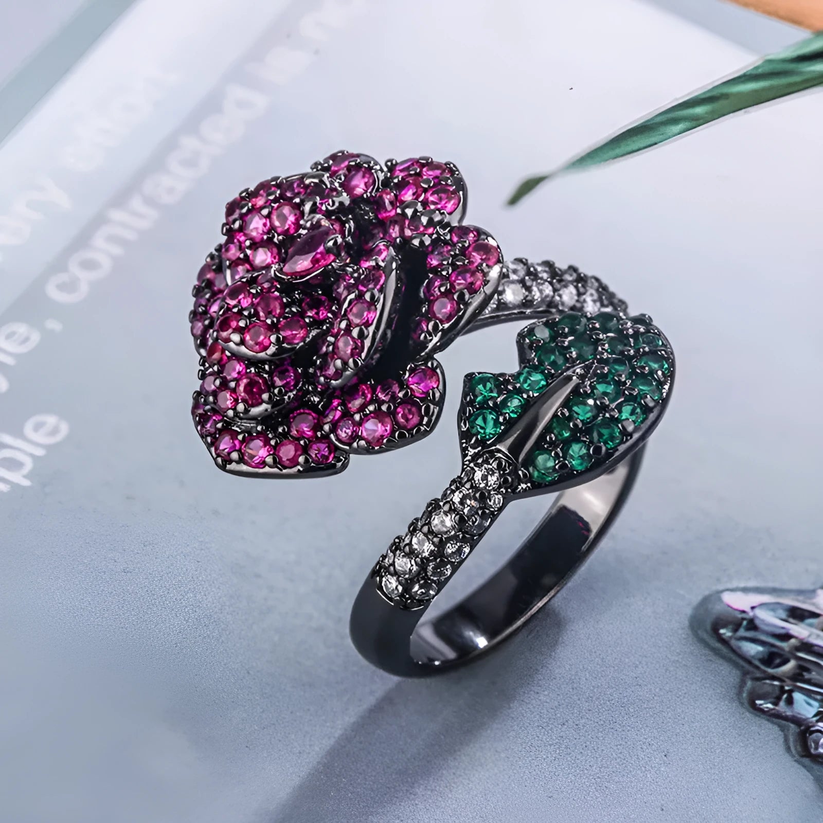 Black gold plated geometric floral ring with a red simulated corundum stone for women.