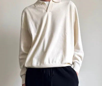 Pure wool polo sweater with lapel collar in loose fit, shown in milky white.