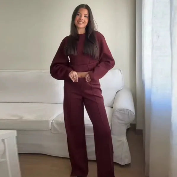 Women's apricot polar fleece suit set with long sleeve top and wide leg trousers on a hanger.