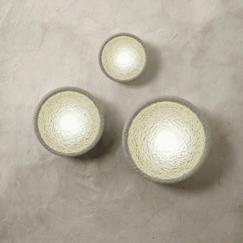 Japanese-style simple silent wall lamp with white resin shade on a wall.