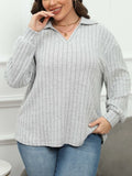 Plus size woman wearing a grey polo collar fleece pullover blouse with lantern sleeves.