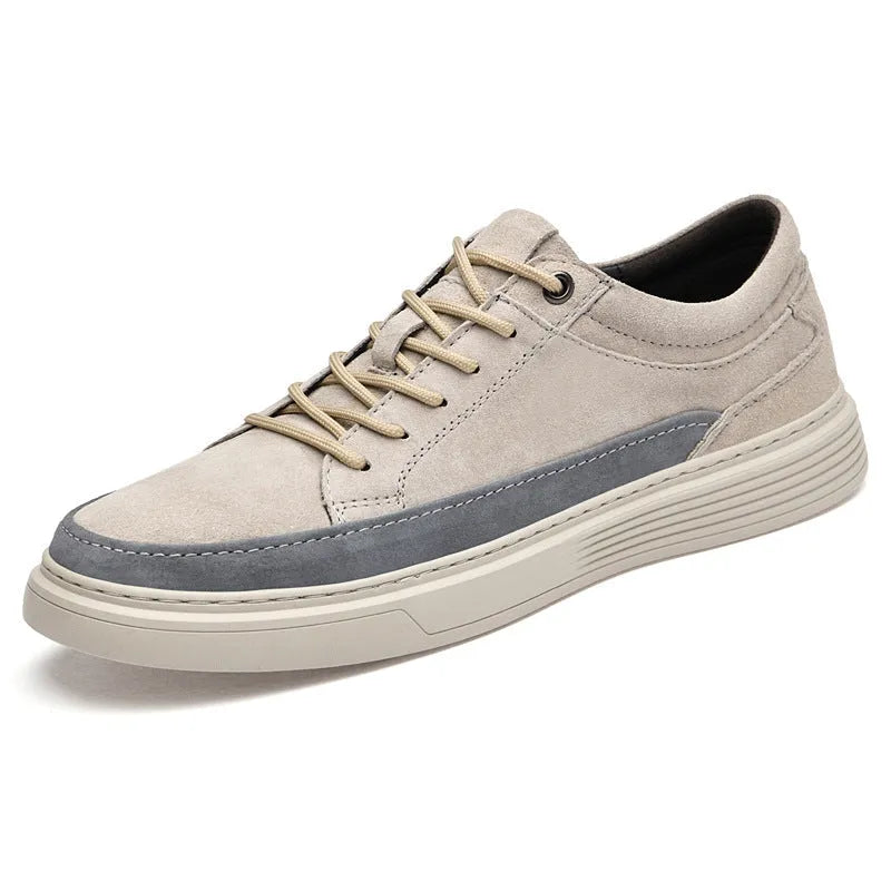 Men's grey low-top pigskin leather skate shoes with flat rubber sole and lace-up front.