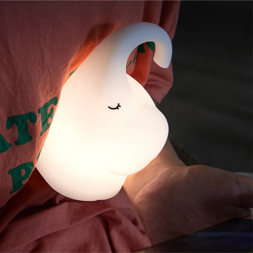 DOMI Elephant-shaped silicone night light with soft white glow on a bedside table