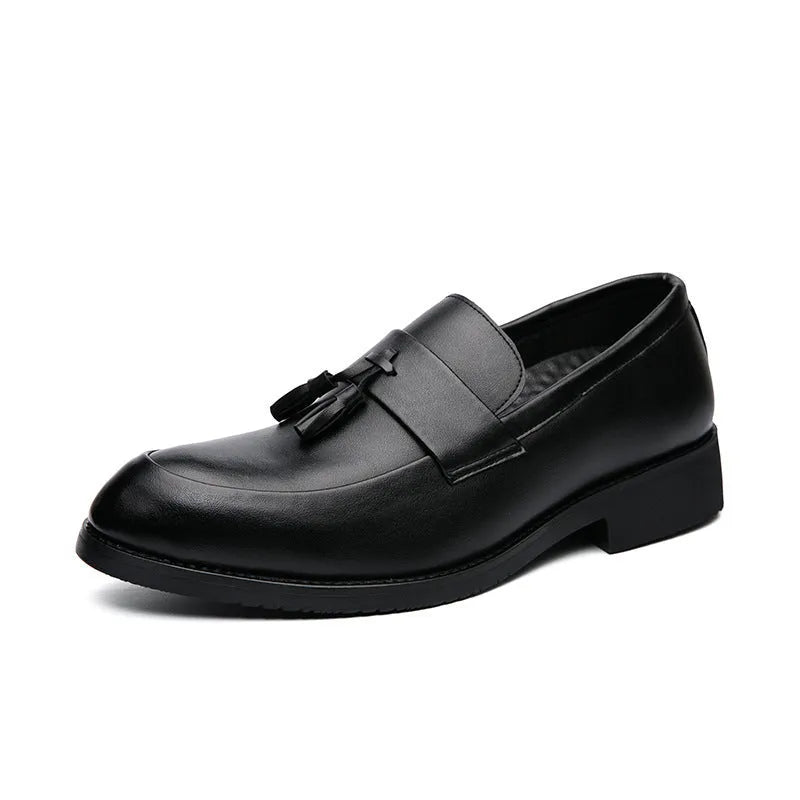Men's black slip-on loafer with tassel detail and rubber sole on white background