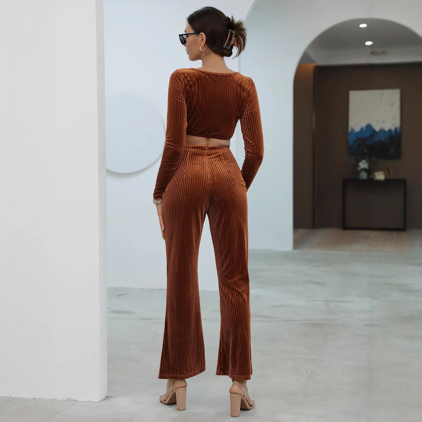 Women's caramel coloured long sleeve sweater and trousers loungewear set on a hanger.