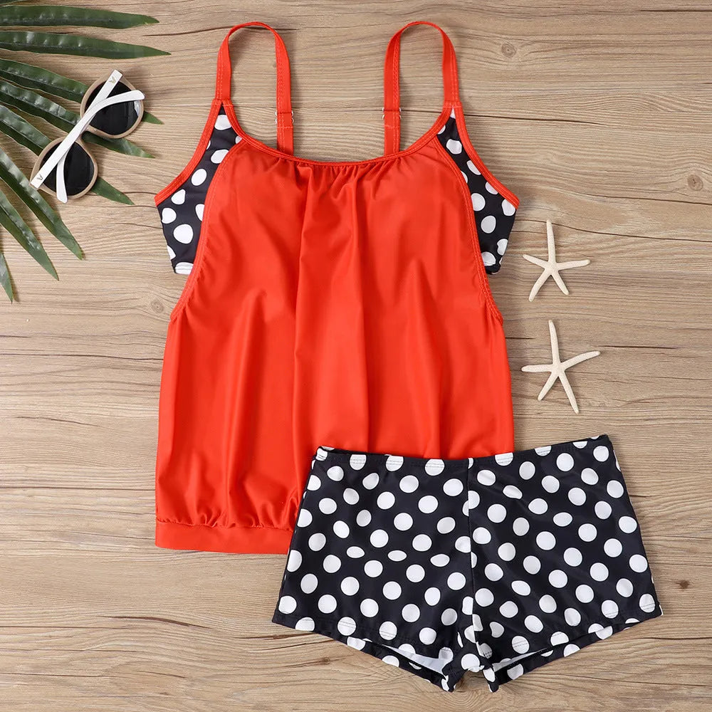 Women's black polka dot boxer swimsuit with high-waisted briefs, made from polyester fabric.