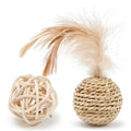 Two cat toys: a natural rattan ball with a bell and a colourful faux feather ball on a plain surface.