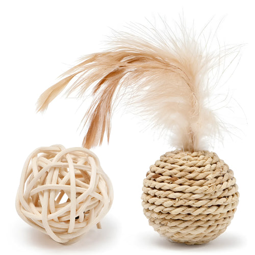 Two cat toys: a natural rattan ball with a bell and a colourful faux feather ball on a plain surface.