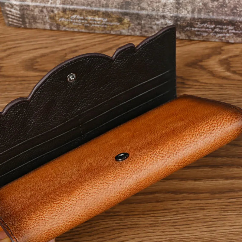 Women's brown tri-fold cowhide wallet with embossed floral pattern, shown open and closed.