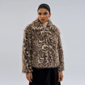 Women's leopard print coat with a buckle lapel fastening, shown in street fashion style.