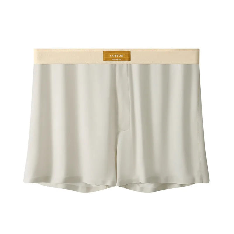 Pack of three pairs of men's solid colour ice silk underwear on a white background.