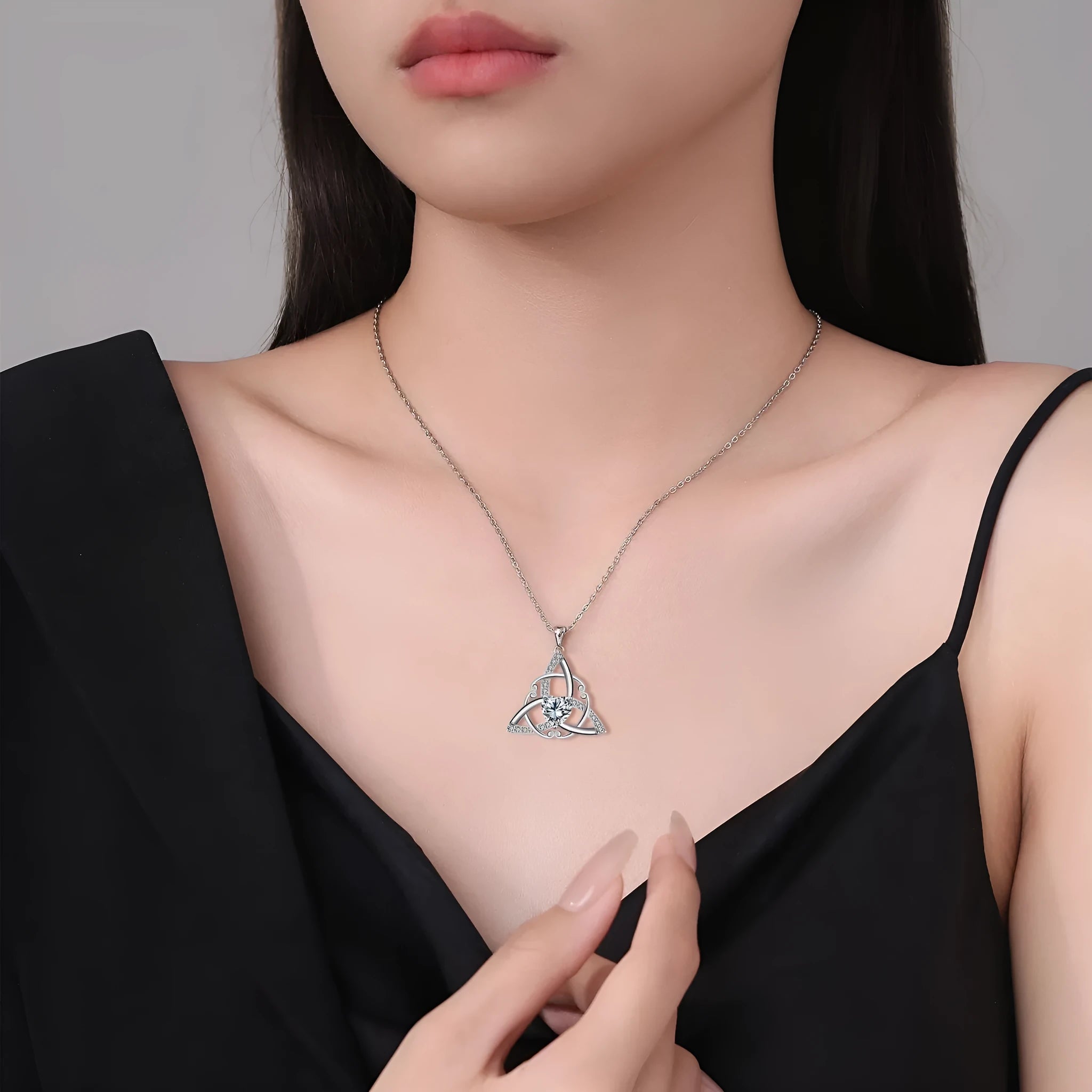 Geometric Celtic knot pendant necklace for women in a choice of blue, lvzuan, red diamond, or white diamond finish.