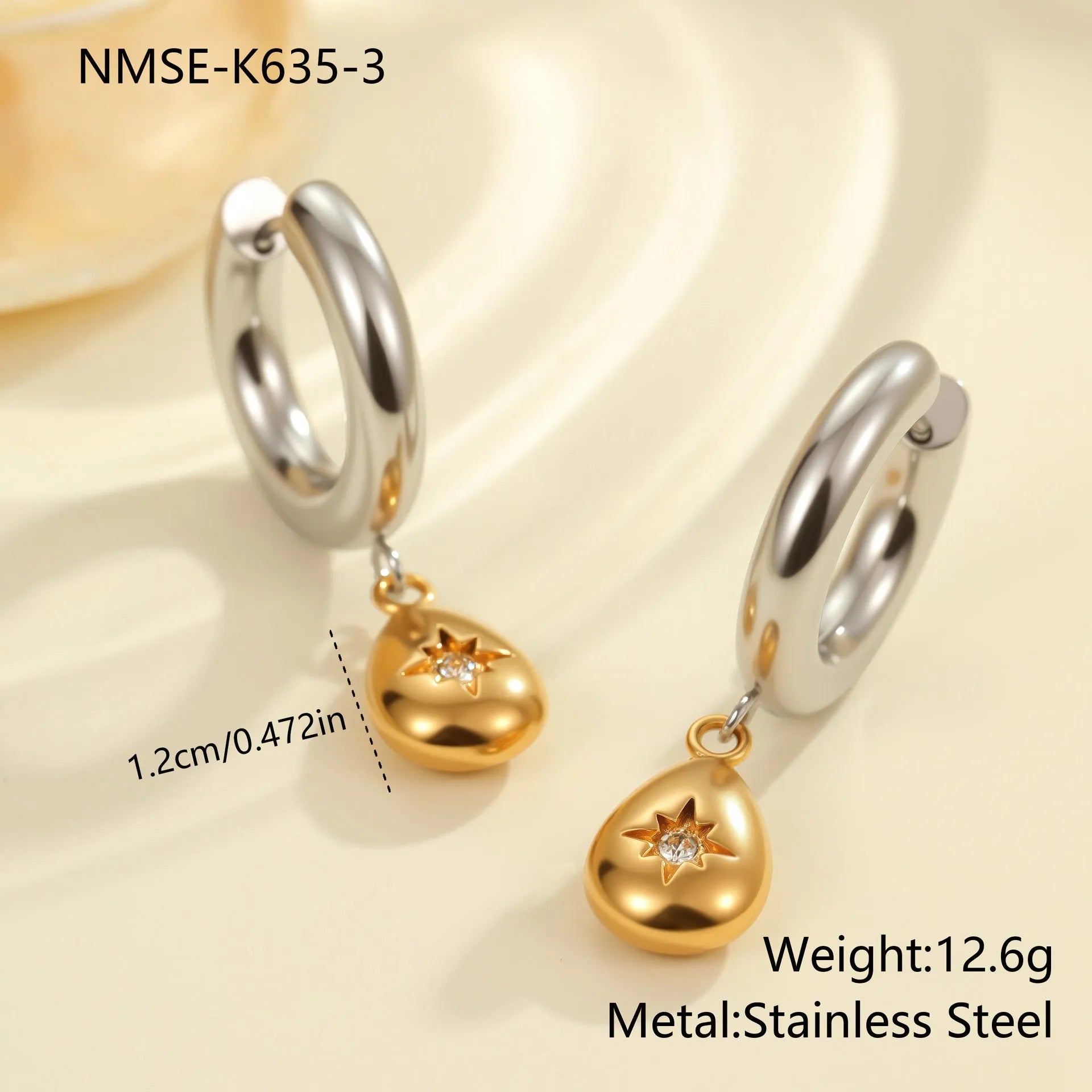 A pair of stainless steel earrings with an 18K gold colour finish, shown in a Christmas tree shape and a heart shape.