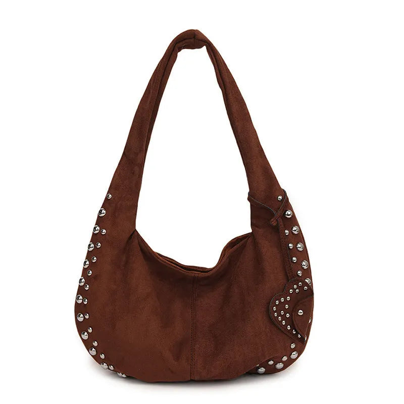 A soft plush underarm tote handbag in a retro style, shown in a colour option.