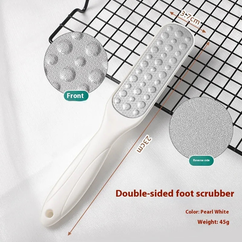Stainless steel foot grinder tool with white and black double-sided sandpaper files for callus removal.
