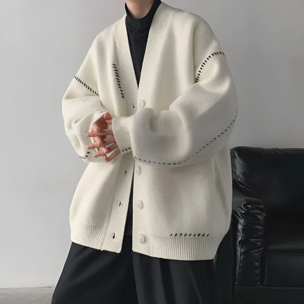Women's loose fit black knitted cardigan coat with long sleeves.