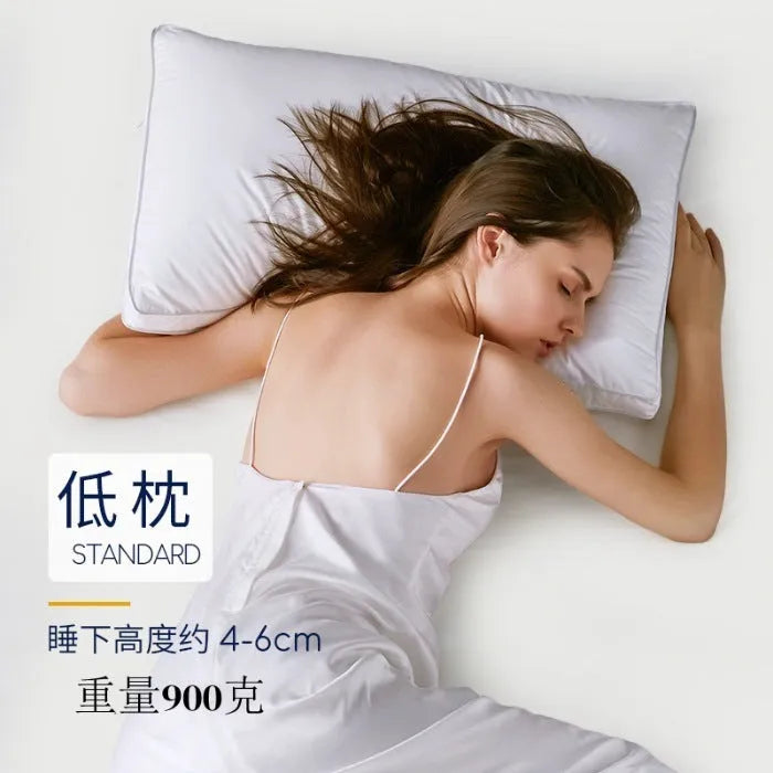 White cotton satin stripe pillow with feather and cotton filling on a bed.