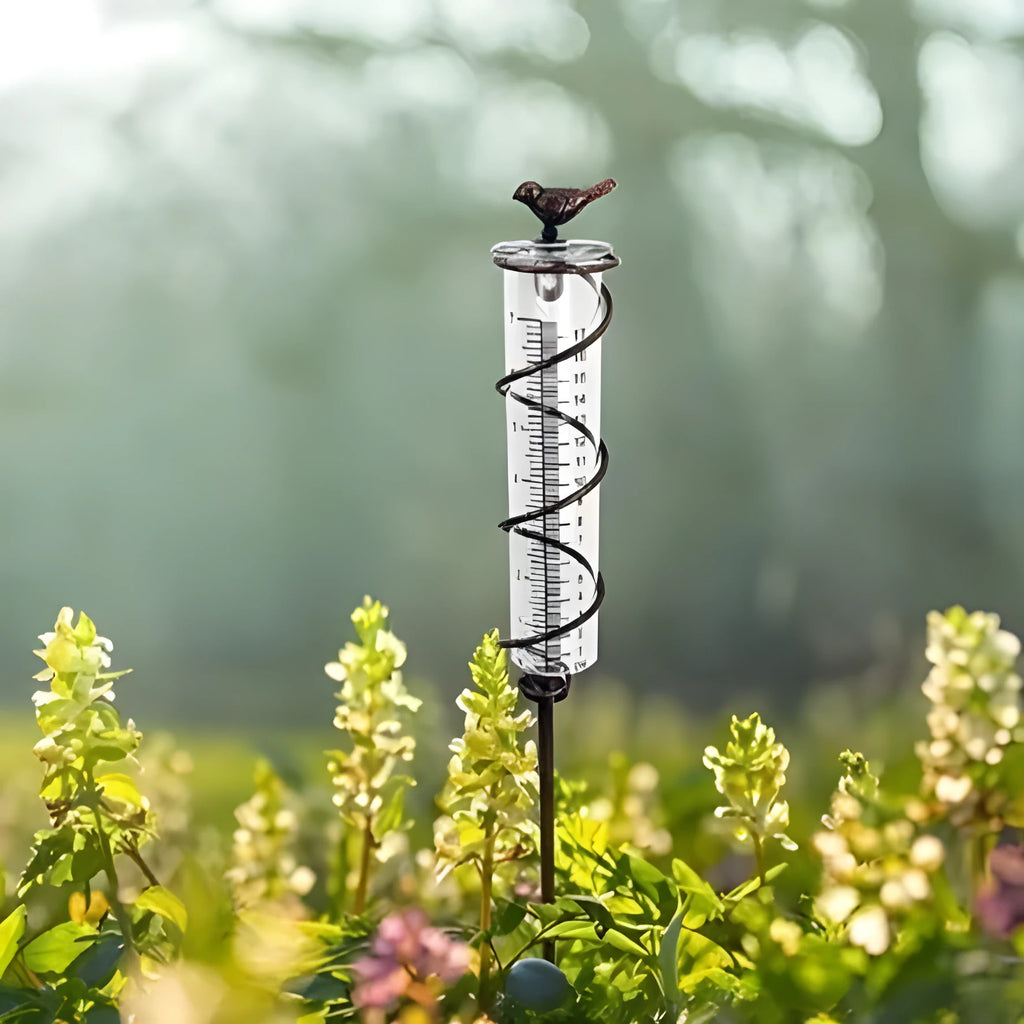 Cast iron bird-shaped garden rain gauge with glass measurement tube showing 1-20 scale