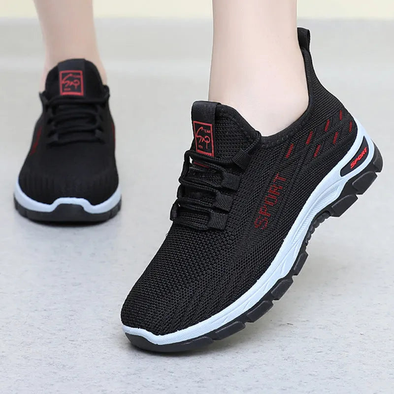 Men's and women's casual low-top sneakers with a soft PVC sole in black, red, light purple, grey, and brown.