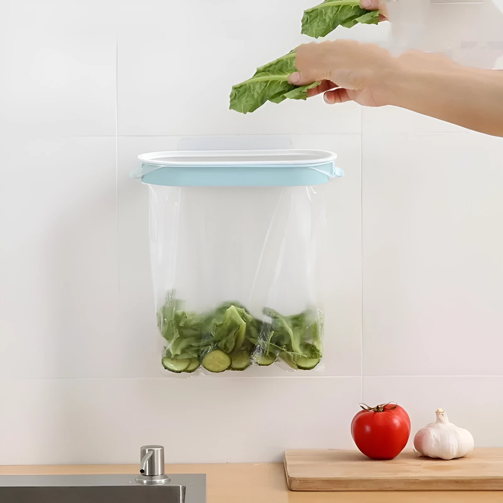 Blue foldable plastic kitchen garbage bag storage rack mounted on a cabinet door.
