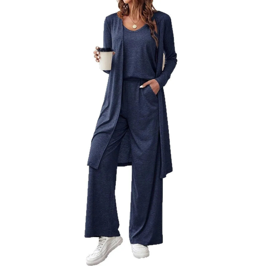 Blue women's polyester suit set with sling top, long cardigan, and trousers on a hanger.