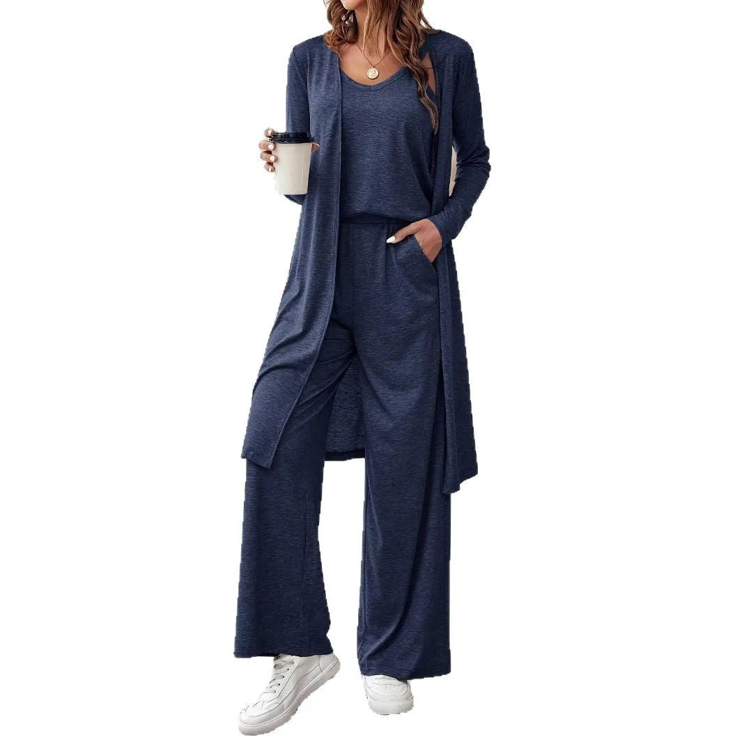 Blue women's polyester suit set with sling top, long cardigan, and trousers on a hanger.