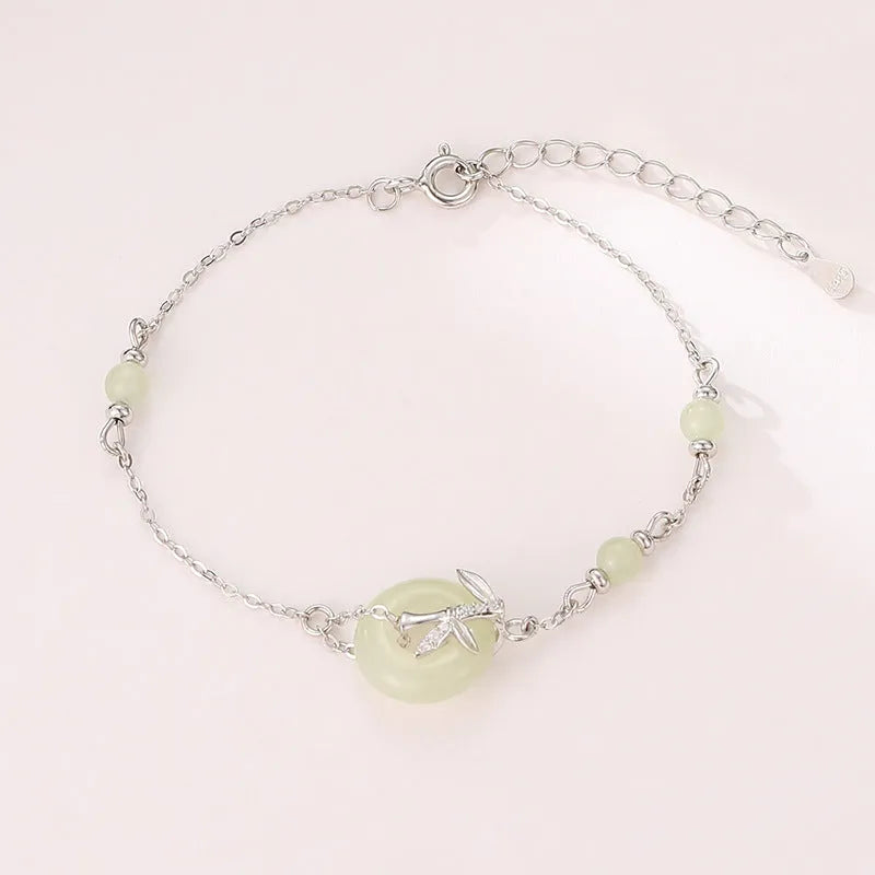 Women's antique-style silver bracelet with a peace symbol safety buckle clasp, shown in gold and silver finishes.