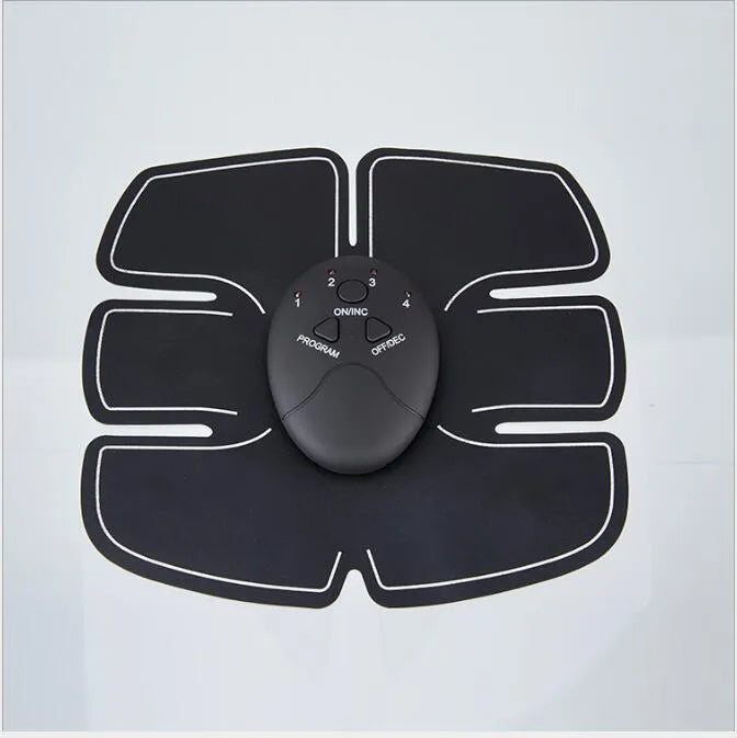 Black EMS muscle stimulator with electrode pads placed on abdomen for slimming and toning