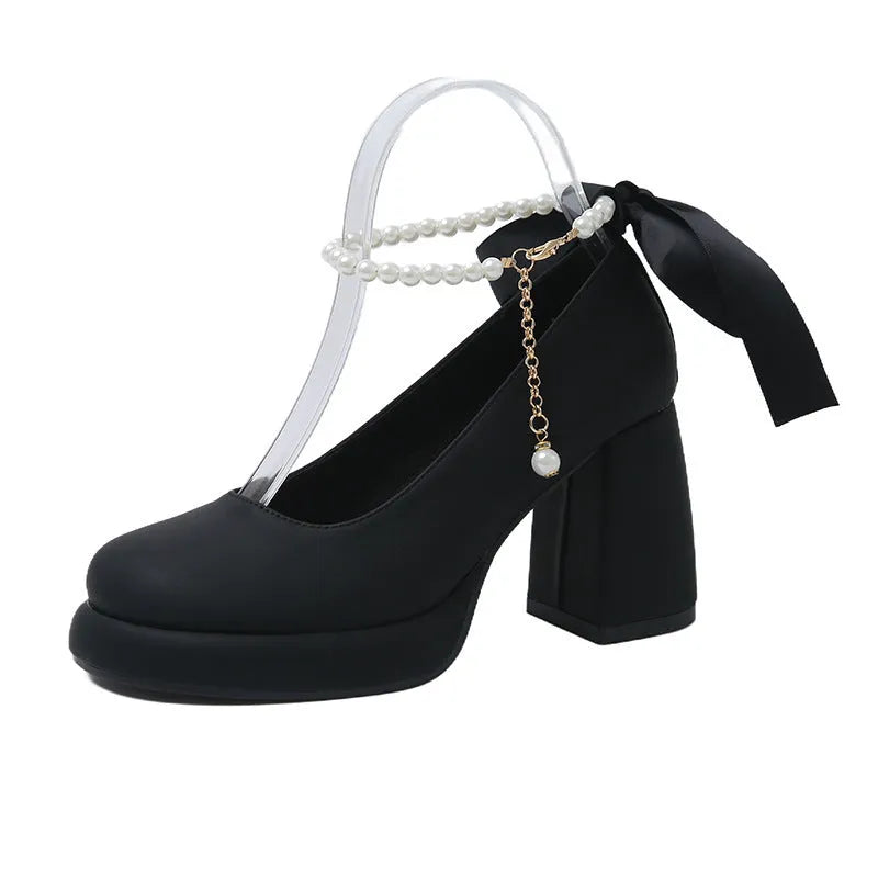 Women's beige Mary Jane shoes with chunky heel and ankle-strap buckle on a white background