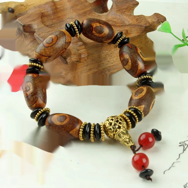 Agate Tibetan dzi bead bracelet with three-eye design and polished finish