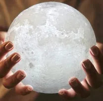 3D printed white moon lamp on wooden stand with colour-changing LED light