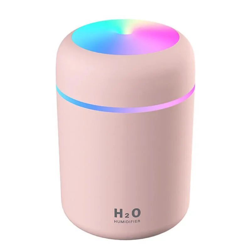 Pink USB portable humidifier with 300ml water tank on wooden desk surface