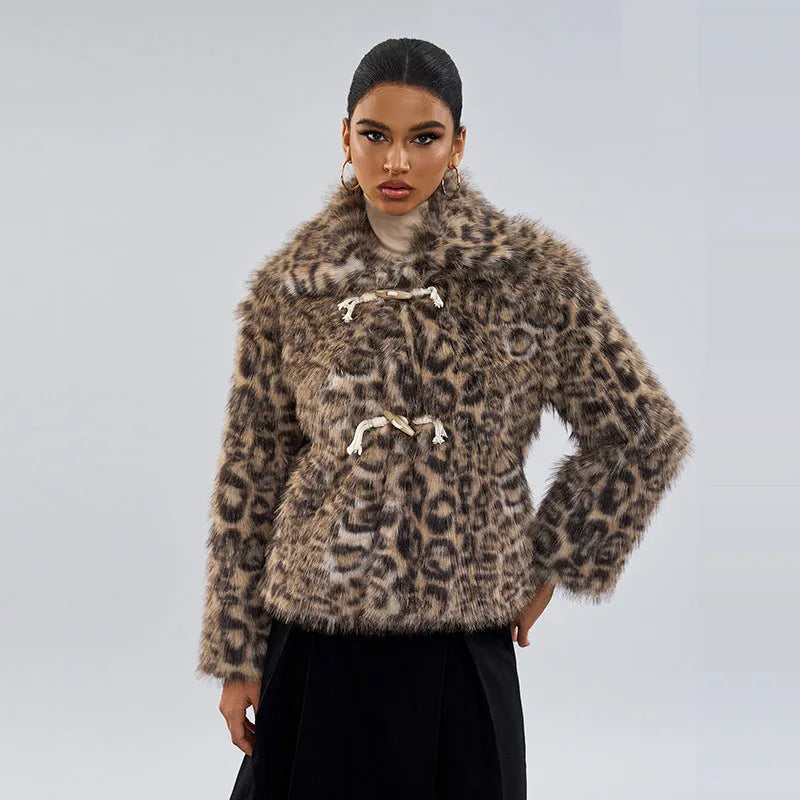 Women's leopard print coat with a buckle lapel fastening, shown in street fashion style.