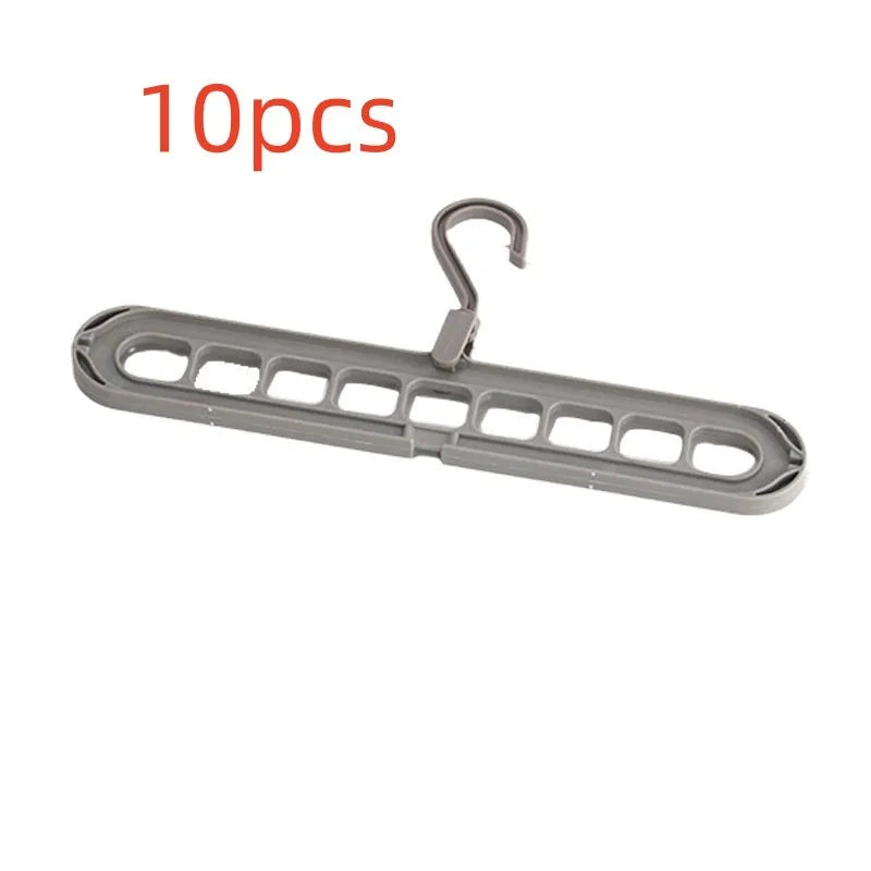 Green plastic nine-hole folding pant hanger for trousers and skirts.