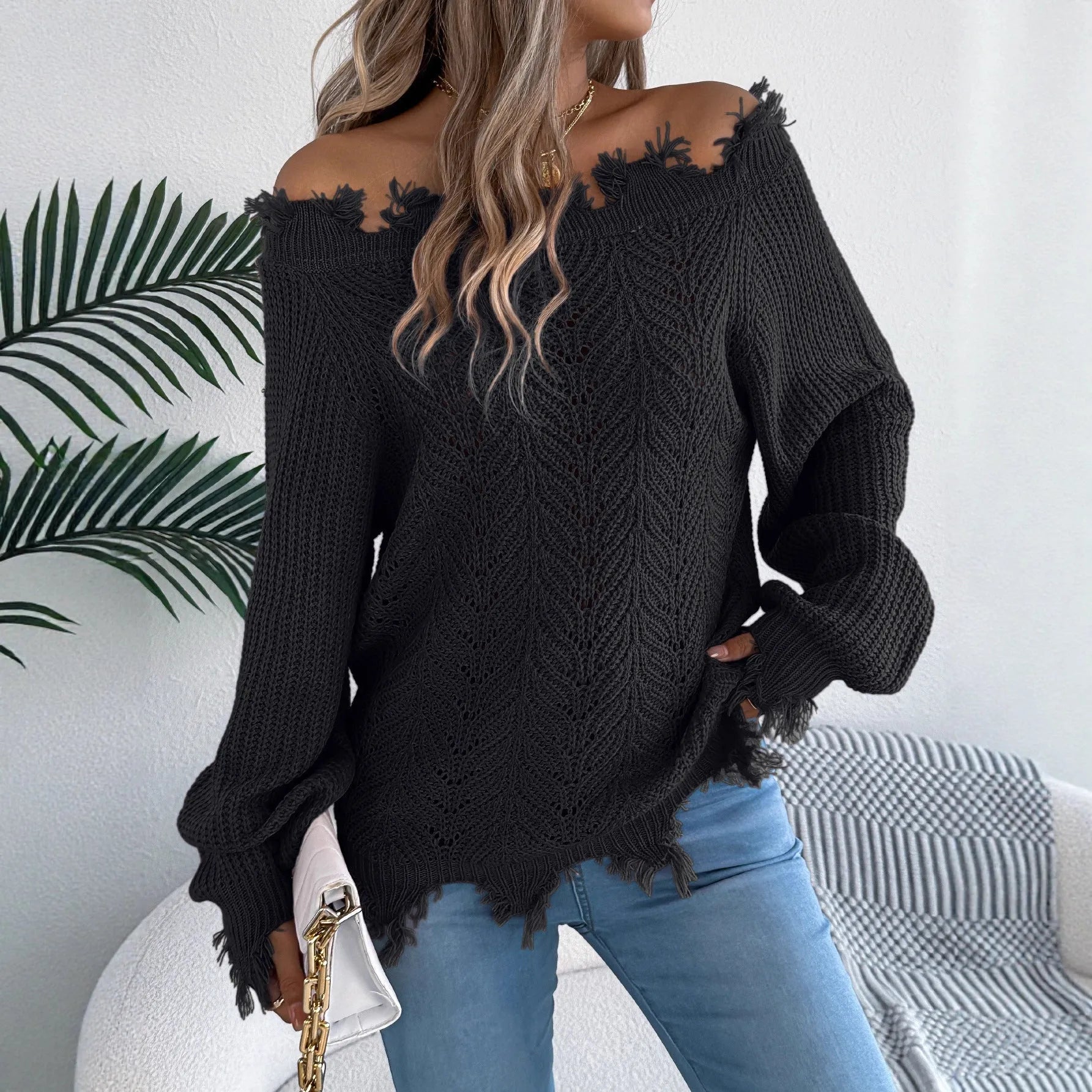 Women's white hollow-out knitted pullover sweater with cut off-the-shoulder neckline and long sleeves.