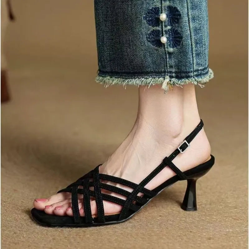 Women's light brown retro sandals with crossed straps, square toe, mid-heel, and ankle buckle on a white background.