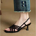 Women's light brown retro sandals with crossed straps, square toe, mid-heel, and ankle buckle on a white background.