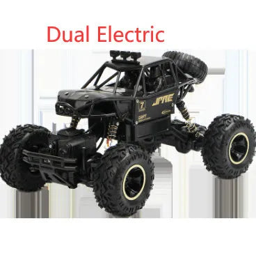 Large black or silver 4WD remote control climbing car on off-road terrain with wireless remote.