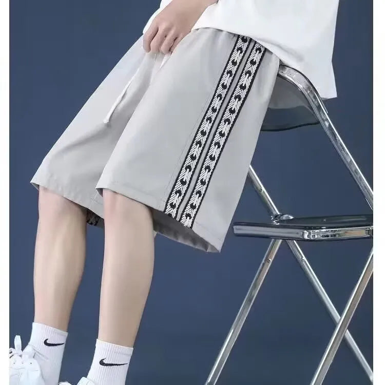 Men's loose-fitting track pants in grey with elastic waistband and baggy leg design