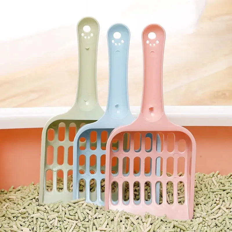 Blue plastic cat litter scoop with a long handle and perforated sifting head on a white background.