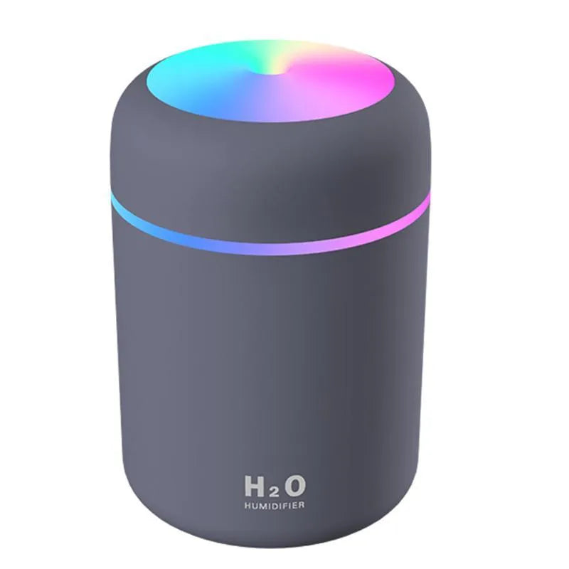 Pink USB portable humidifier with 300ml water tank on wooden desk surface