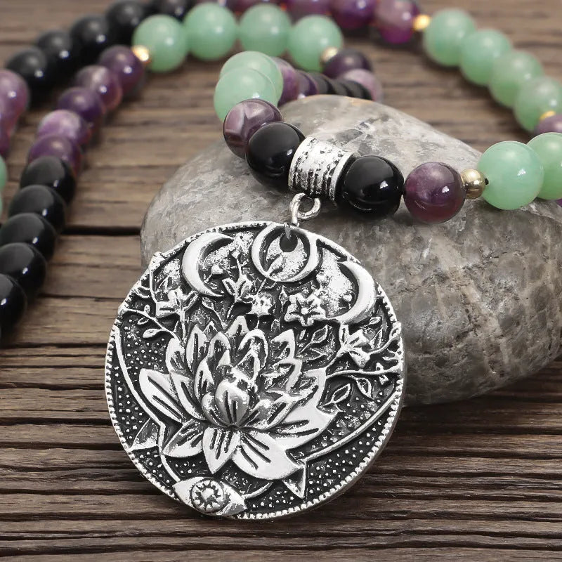 Lotus pendant necklace with stone beads on adjustable ball bead chain alongside matching bracelet