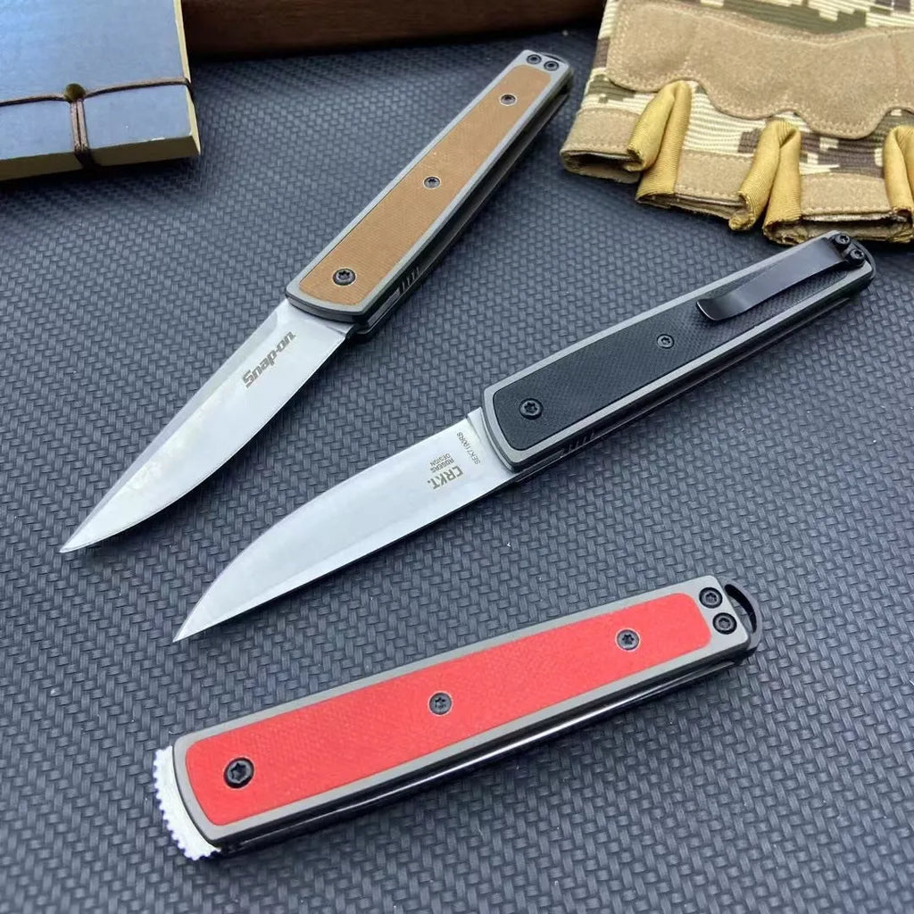 Folding fruit knife with stainless steel blade shown in black, brown, and red colour options