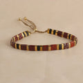 Adjustable pull beads bracelet with glass and coloured glaze beads in geometric and round shapes