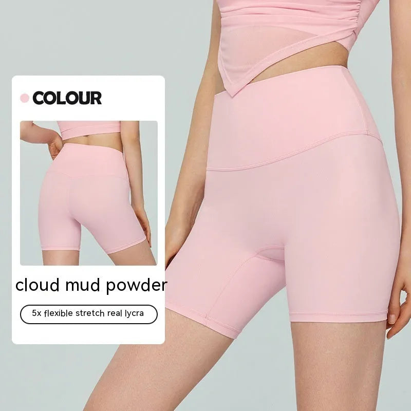 Women's high-waisted Lycra yoga shorts in leaf green, showing anti-exposure construction and short length.