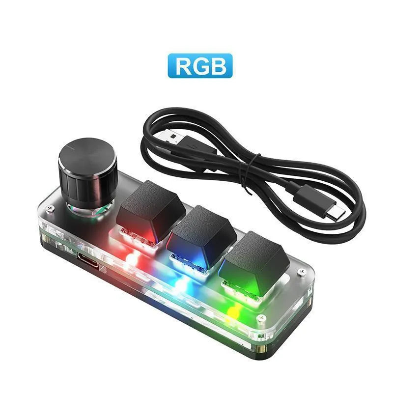 Compact black USB mini keyboard with RGB backlit keys labelled Copy and Paste on a desk.