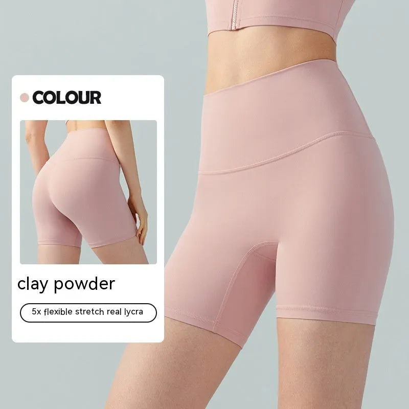 Women's high-waisted Lycra yoga shorts in leaf green, showing anti-exposure construction and short length.