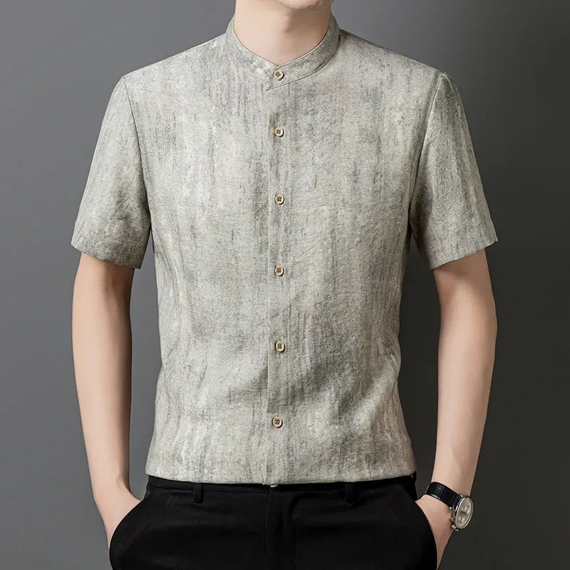 Man wearing a loose grey linen shirt with a stand collar and short sleeves, cardigan style.