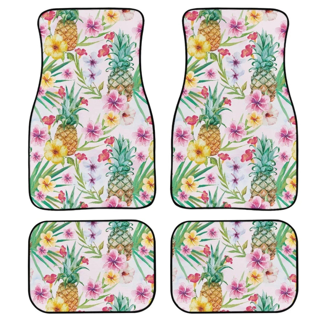 Four-piece set of thick black rubber car floor mats with printed patterns laid out for a vehicle.